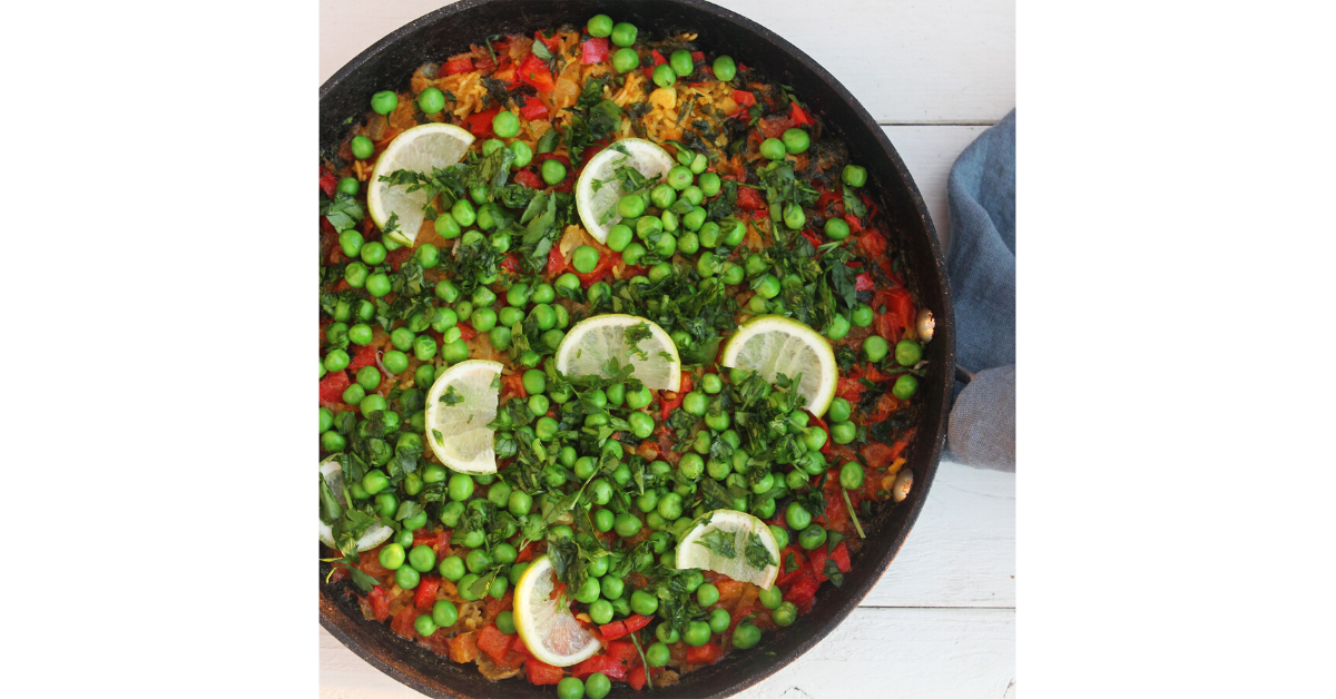 vegan paella with lime, peas, tomatoes and spices